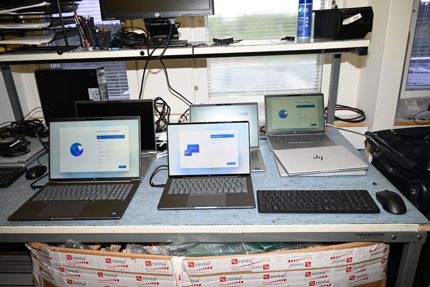 HP computers being tested and configured on a workbench in Sollentuna